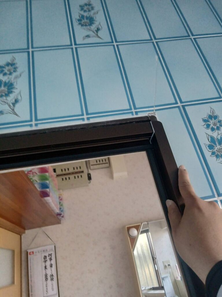 新しい浴室折れ戸枠を既設枠へ取り付ける作業